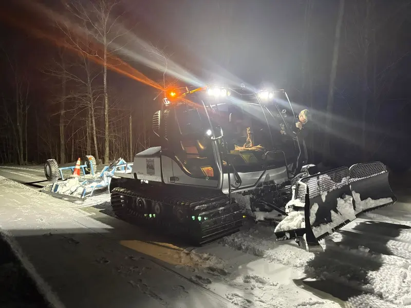 Trail groomer working at night on western Maine snowmobile trails